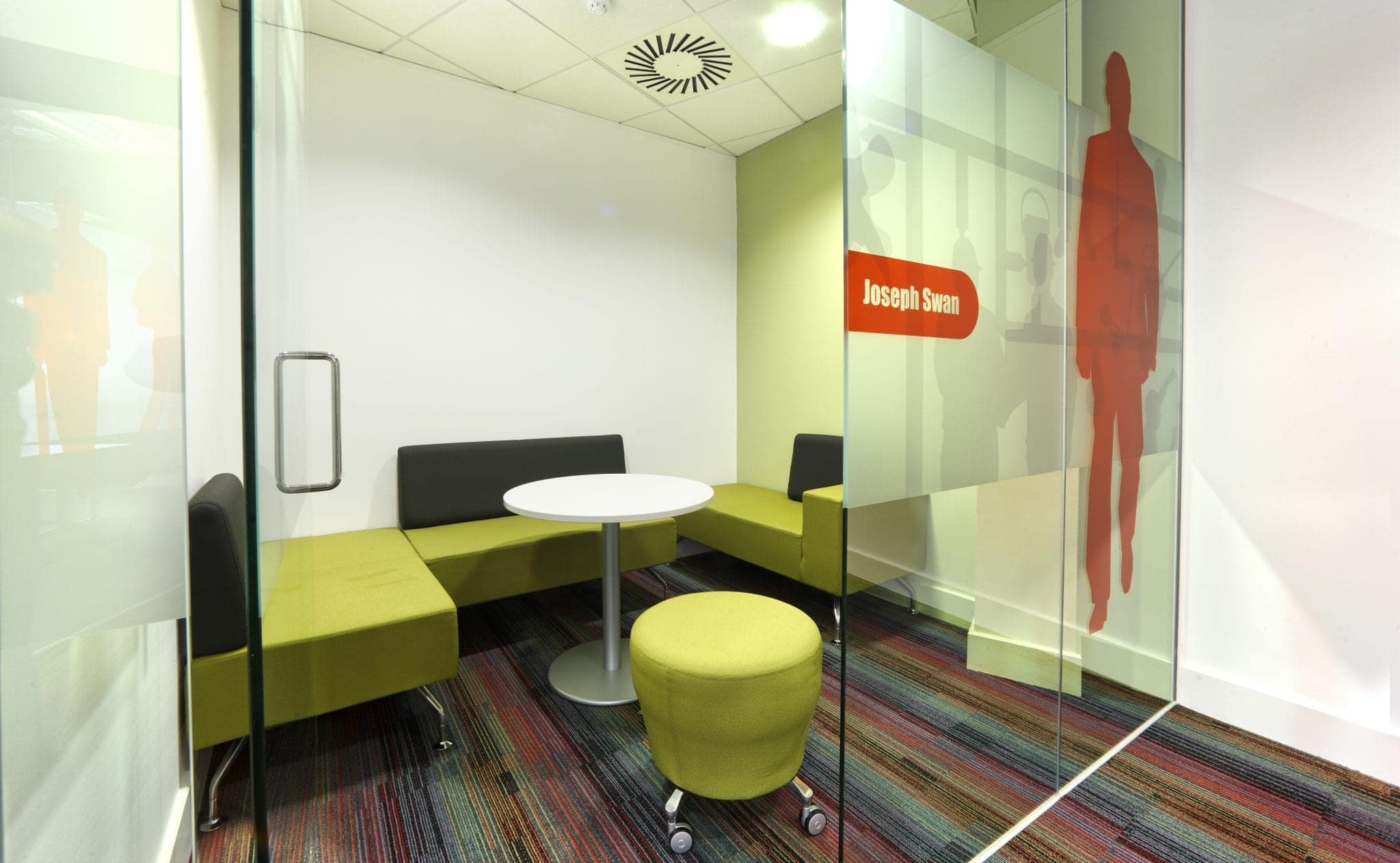 Green breakout space with informal seating at Balfour Beatty Workplace, Bristol