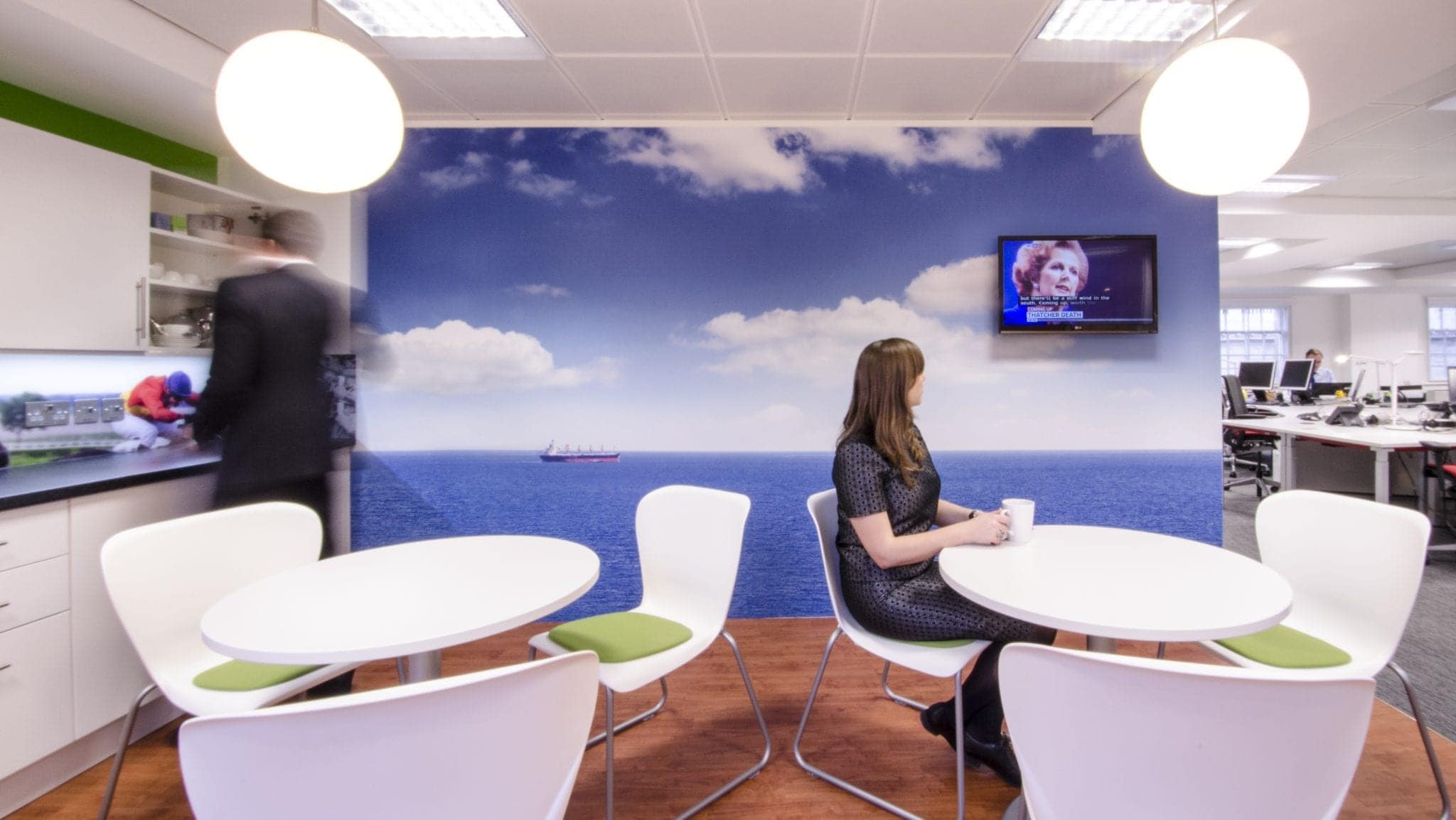 Breakout area with a large blue wall graphic at Marine Capital