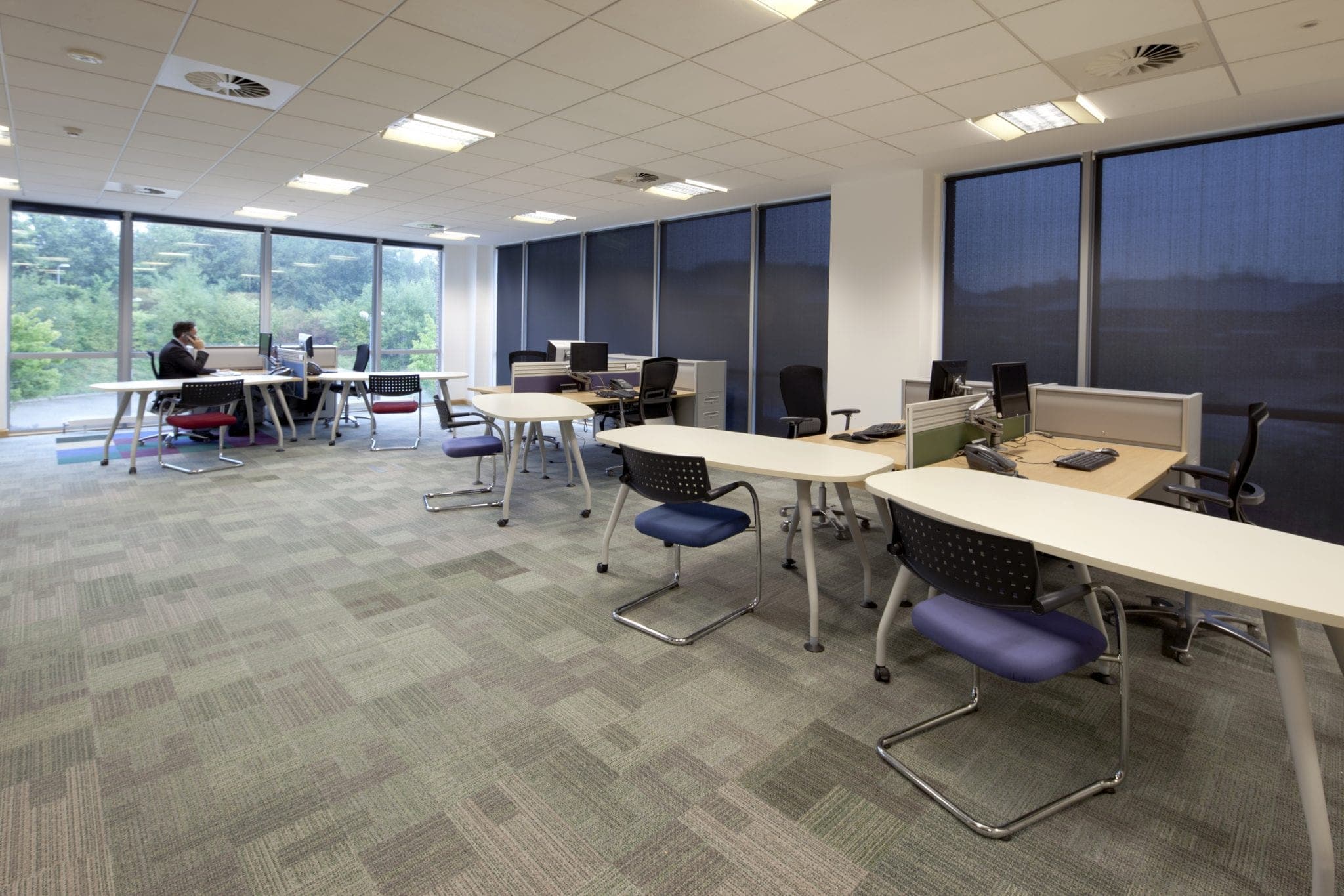 Open-plan office floor with rows of desks and storage at Michelmores, Exeter