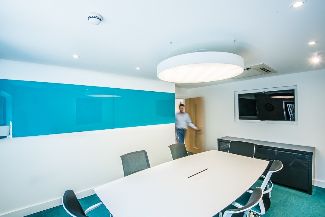 Meeting room with a blue feature wall at Oxford Capital