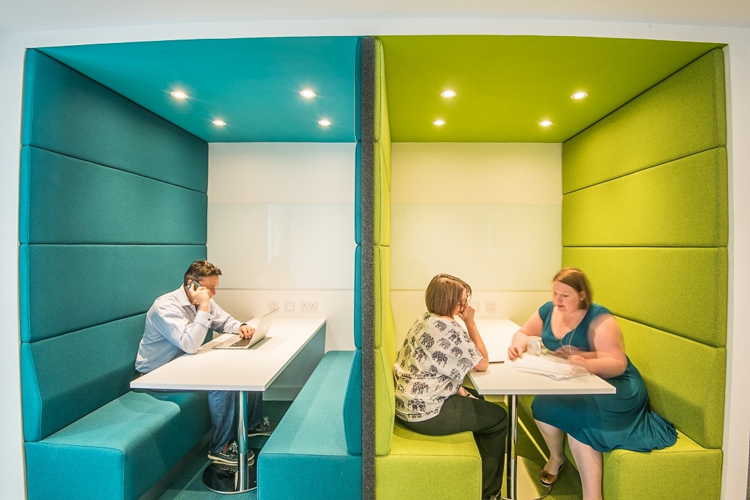 Green upholstered booth for small meetings at Oxford Capital
