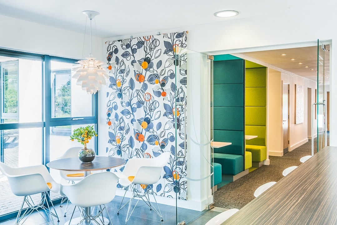 Colourful artwork wall beside glazed meeting rooms at Oxford Capital